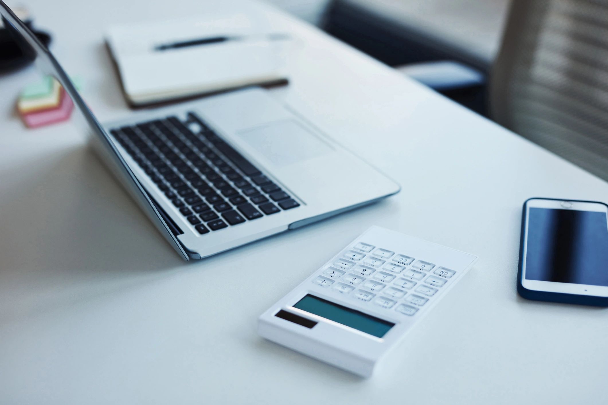 Calculator and laptop on an office table