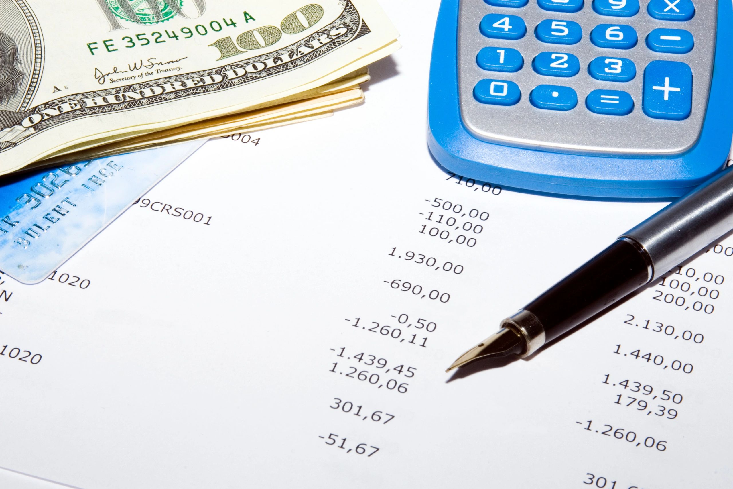 Calculator and pen on financial reports representing cash flow operations