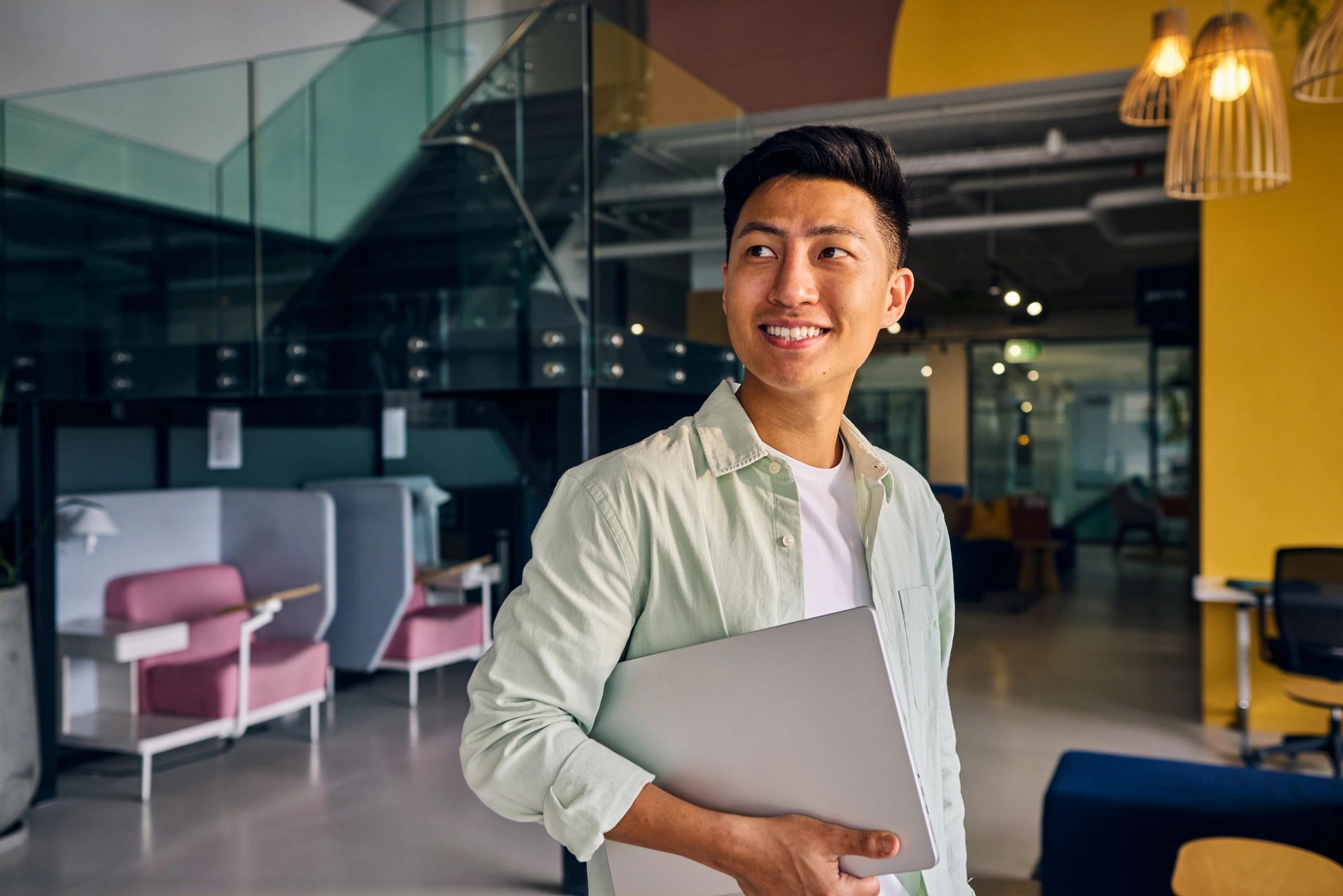 Portrait of a smiling freelancer holding a laptop