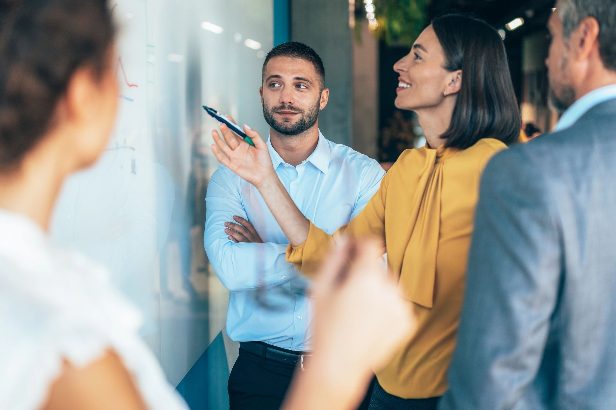 Team planning a workflow on a whiteboard